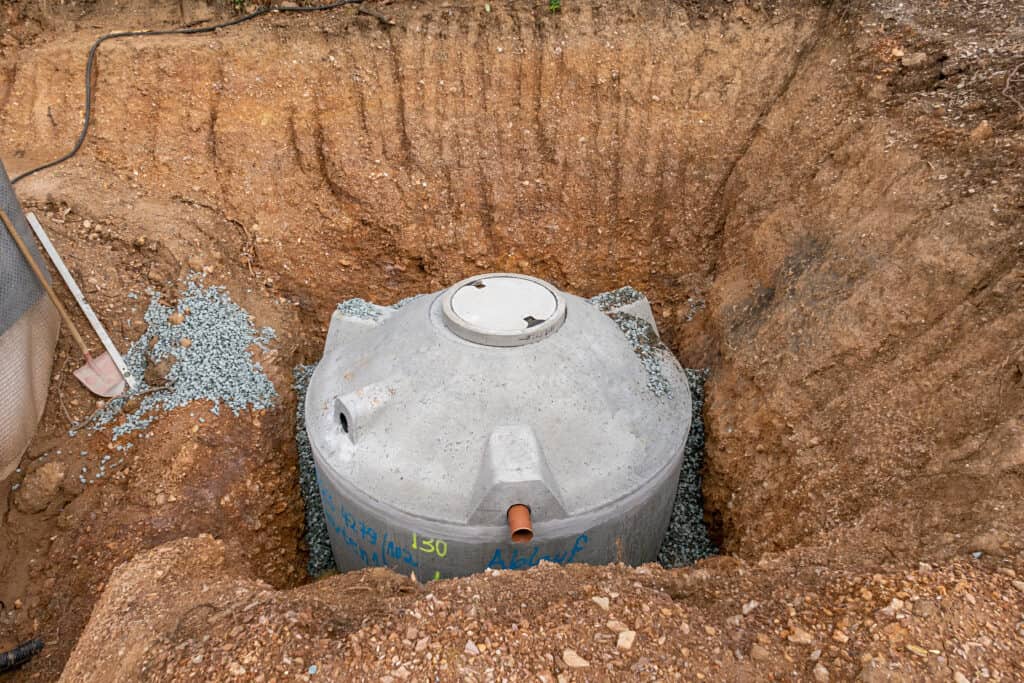 Concrete tank installed in a dug-out area