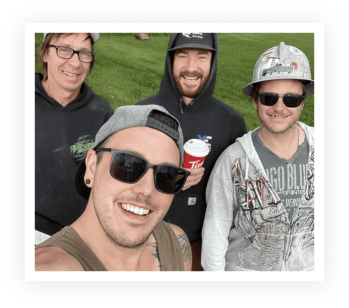Group of four friends smiling outdoors