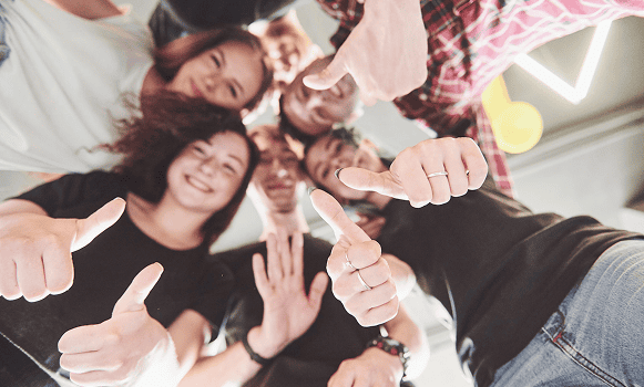 Group of people showing thumbs up together.