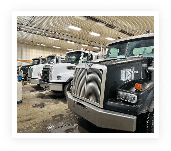 Line of commercial trucks in a garage