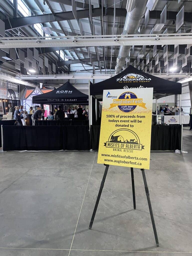 Augtoberfest event sign promoting animal rescue donations.